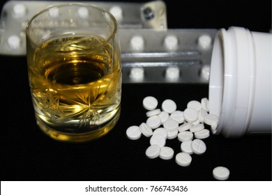Benzodiazepines or other pills and glass of alcohol