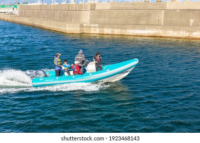 BEPPU, KYUSHU, Japan, October 3, 2017: a Japanese family swims on an inflatable rubber boat with a motor on the waves of the bay near the city of Beppu on the island of Kyushu.