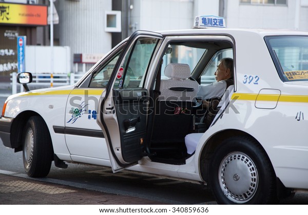 BEPPU, OITA,\
KYUSHU, JAPAN - 27 NOVEMBER 2014 : A taxi driver service waiting\
the passenger at Beppu\
station.