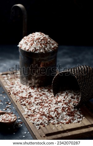 Beras or mix of red and white rice grains on a chopboard. Stock photo © 
