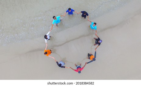 Berau, Mar 7, 20217. Some People Make A Circle While Holding Hands In Front Of The Beach, Seen From Above. View On Top.