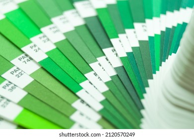 Berdsk, Russia - 9 Feb 2022: Pantone Color Guide. Palette Of Green Color Shades. A Sample Of The Chromaticity Of The Colors System. Reference Colors Of Paints. Selective Focus