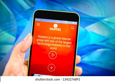 Berdyansk, Ukraine - March 19, 2019: Naspers website homepage. Naspers logo visible on the phone screen. - Shutterstock ID 1343276891