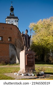 Berdychiv, Ukraine - 2021.10.22: The Sculpture Of Pope John Paul II In Front Of Medieval Walls Of The Monastery Of The Barefoot Carmelites