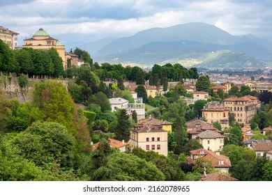 Bergamo, Italy - 29 May 2022: View on Bergamo city with the city wall of Bergamo Alta and alpine landscape at the background