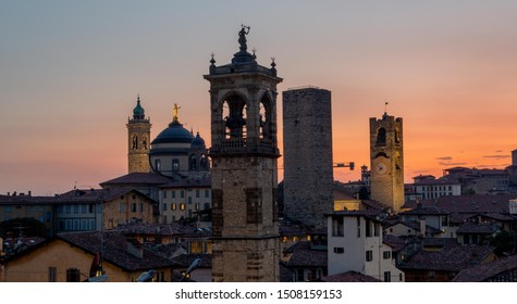 Bergamo at sunset in the old city with towers and bell tower