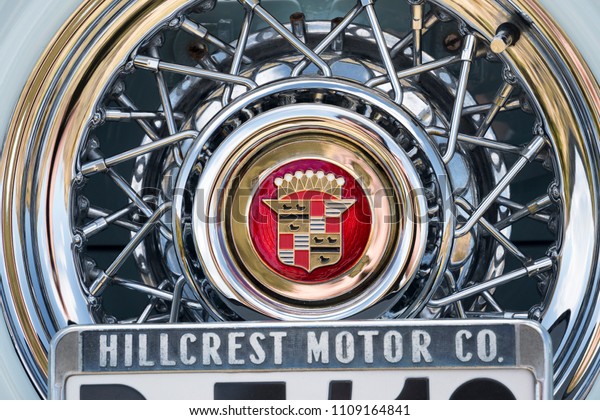 BERGEN, NORWAY - 4/29/18: Detail view of the\
spare spoked wheel above license plate of a 1954 Cadillac Eldorado\
convertible during an american car owners meeting on a sunny spring\
day in the mountain.