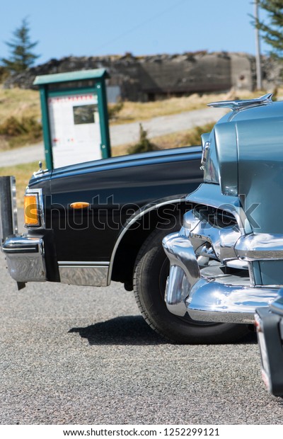 BERGEN, NORWAY - 4/29/18: Side profile view of\
row of classic american cars including 1954 Ford 4 door and and\
1981-1985 Chevrolet Caprice Classic, parked in a mountain tourist\
area during a meeting.