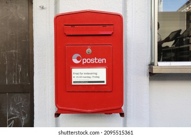 BERGEN, NORWAY - JULY 23, 2020: Red post box of Posten Norge (The Norwegian Post) in Bergen. Posten was founded in 1647.