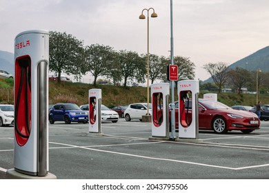 Bergen, Norway - Sep 18, 2021: Tesla supercharging station. Electric cars parked in the open air.