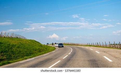 Bergheim, France - Apr 19, 2019: Seat, Porsche Convertible And Two Motorcyclists Driving In Convoy On The French Village Road