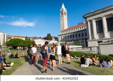 BERKELEY, CA- Apr 16, 2016: Students at the University of California Berkeley campus enjoying a warm spring day outdoors on the grass. The Campanile tower is seen in the background.