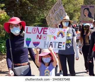 Berkeley, CA - Mar 28, 2021: Unidentified participants at Asian American Pacific Islander Youth Rising Rally marching from Aquatic park to the pedestrian 80 freeway over pass. Anti Asian Hate Rally.