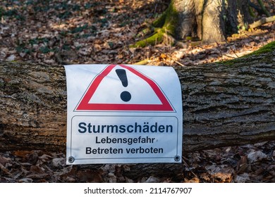 Berlin 2022: A Sign In The Forest Warning Of Storm Damage (Sturmschäden) And Indicating Danger To Life. It Is Forbidden To Enter.