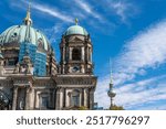 Berlin Cathedral against a blue sky with the Berlin TV Tower in the background. Close-up of Berlin Cathedral.