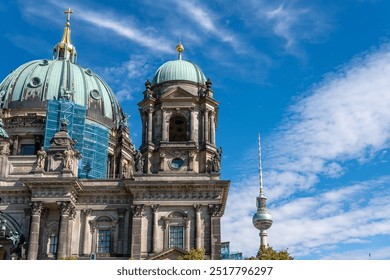 Berlin Cathedral against a blue sky with the Berlin TV Tower in the background. Close-up of Berlin Cathedral. - Powered by Shutterstock