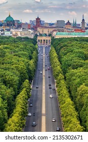 Berlin city skyline in Germany, aerial view above street through Tiergarten park towards the Brandenburg Gate.