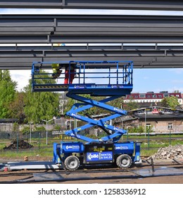 Berlin, Federal Republic Of Germany - April 27, 2018: Construction Work At Height Using Electric Rough Terrain Scissor Lift Of Model GS-2669 DC..