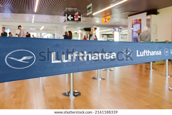 Berlin, GER, May 2022: blue belt barrier with\
white Lufthansa airlines logo. Lufthansa is Germany flag carrier.\
Travel and airport\
security