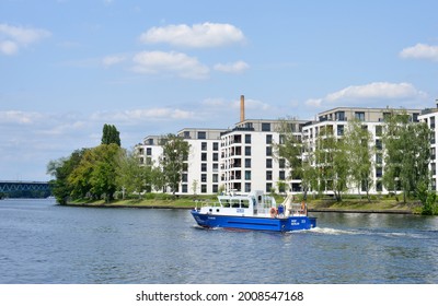 Berlin, Germany 07-13-2021 A Patrol Boat Of The Water Police Passing On The River Spree New Build Appartment Houses 