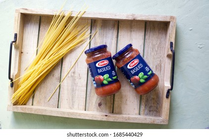 Berlin, Germany 3/28/2020 A Rustic Tray With Barilla Pasta Sauce Basil Flavour. Wonderful And  Easy To Pour Over Boiled Spaghetti. Flat Lay Image With Copy Space