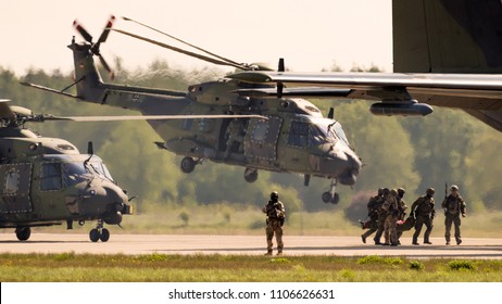 BERLIN, GERMANY - APR 27, 2018: German Military NH90 Troop Helicopter And Special Forces Performing A Military Demonstration At The Berlin ILA Air Show.