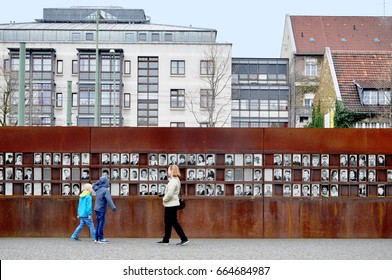 Berlin, Germany - April 12, 2017: Monument of the Berlin Wall with photos of people and visitors.