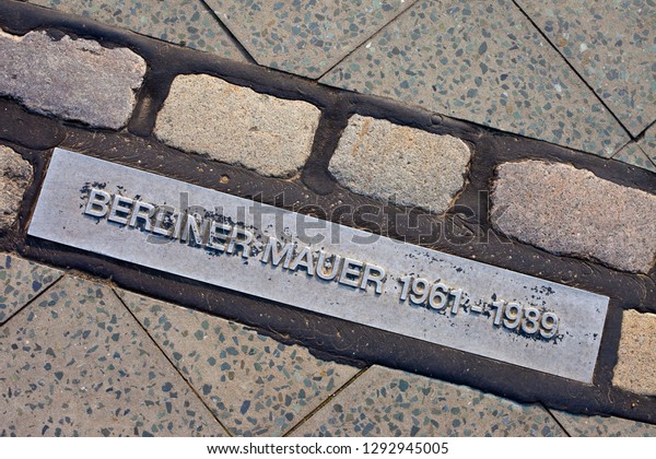 Berlin, Germany - April 18th 2011: Translated into\
English, Berliner Mauer means Berlin Wall and this marker\
commemorates where the wall stood in Berlin. The markers can be\
found throughout the\
city.