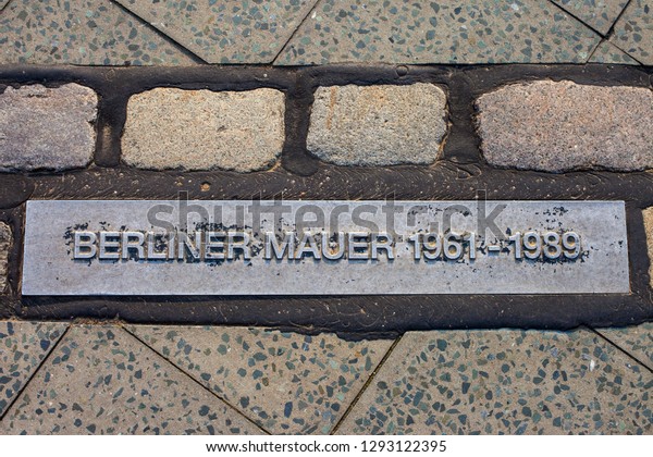Berlin, Germany - April 18th 2011: Translated to\
English, Berliner Mauer means Berlin Wall and this marker shows\
where the wall once stood in Berlin. These markers can be found\
throughout the city.