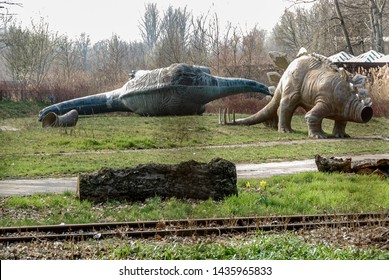 Berlin, Germany, April 2009. Abandoned and overgrown dinosaur statues tossed over and beheaded in former East German amusement park Spreepark Plänterwald.