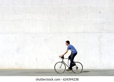 Berlin, Germany, April 25, 2006: Unidentified bicycle riders near Berlin parliament building. Bicycles are the best way to see the most Berlin interesting sites. Concrete wall background