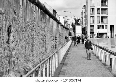 BERLIN, GERMANY - AUGUST 26, 2014: People visit historical Berlin Wall. Berlin Wall was a historical barrier that existed from 1961 through 1989.