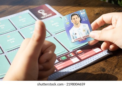 BERLIN, GERMANY - AUGUST 28, 2022: Boy With Lionel Messi Sticker And Panini Album For The Football World Championship 2022 In Qatar.