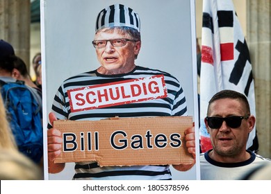 Berlin, Germany, August 29., 2020: Supporters of the Qanon conspiracy theories hold a poster with the photo of Bill Gates and the inscription "guilty"