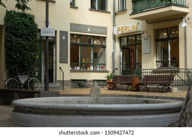 Berlin, Germany, August 30/2019 - Small Shops, A Fountain And Two Park Benches Adorn One Of The Many Courtyards Of The Famous Hackesche Höfe In Berlin Mitte.