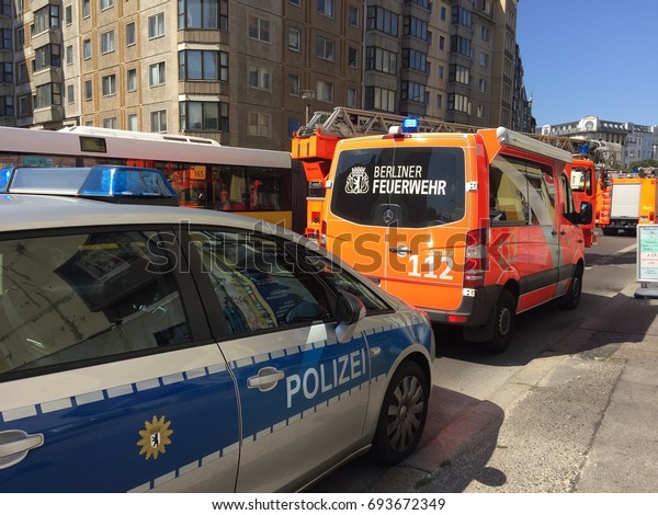 Berlin, Germany - August 9, 2017: German\
national police car and fire department service truck. 112 is the\
European emergency number that can be dialed free of charge for\
fire and medical\
emergency