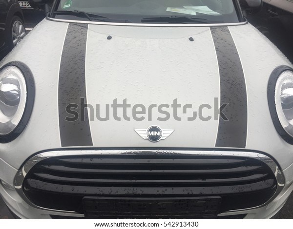 Berlin, Germany - December 19, 2016: white Mini\
Cooper car. It is a model produced by BMW since 2000. BMW is a\
German luxury vehicle, motorcycle, and engine manufacturing company\
founded in 1916