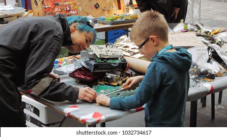 Berlin, Germany, December 2017: Young Boy Disassembles Computer Motherboard At A Public Maker Space Event In Berlin.