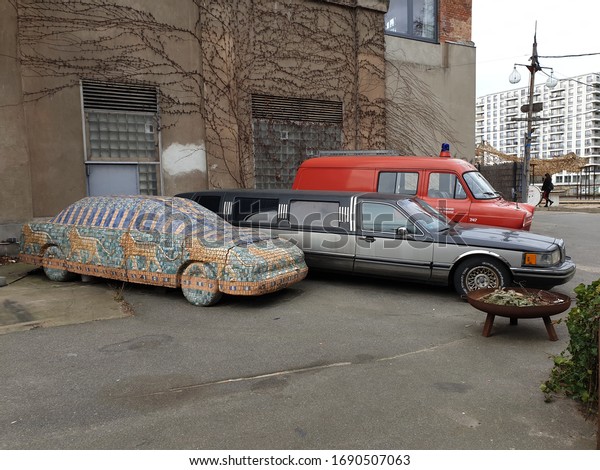 BERLIN, GERMANY.\
February 17, 2020. Parts of the Berlin wall and rarity vintage cars\
inside the public Zalando Outlet Store complex. This place was\
designed to attract\
tourists.
