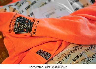 Berlin, Germany - January 12, 2021: Orange Camp David Sweatshirt On A Plastic Shipping Bag.