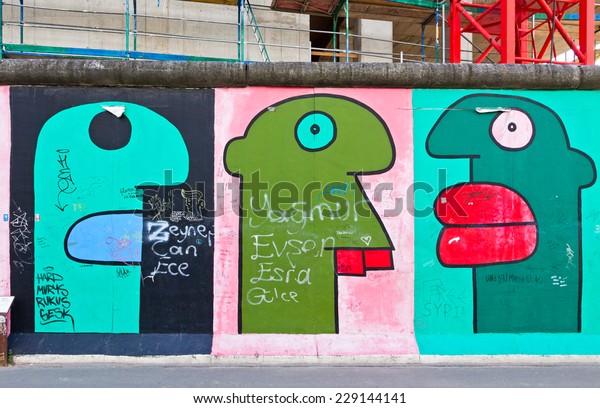 BERLIN, GERMANY - JULY 2, 2014: East Side Gallery in\
Berlin. It\'s a part of original Berlin Wall. Nowadays world\
celebrates the 25th anniversary of Fall of the Berlin Wall, which\
collapsed in 1989