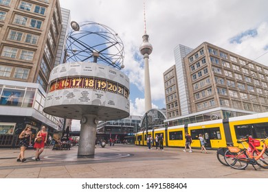 Berlin / Germany - July 2019: Tourists exploring the Urania World Clock in Berlin. Since its erection in 1969, it has become a tourist attraction and meeting place.