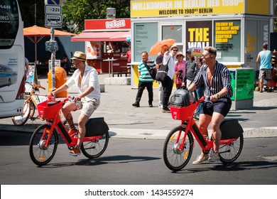 Berlin, Germany - June, 2019: Tourists Riding Electric Bike Sharing Bicycles, JUMP By UBER On Street In Berlin, Germany