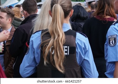 Berlin, Germany - June 4, 2017: Back Turned Female Police Officer At Work During A Street Parade. Law Enforcement In Germany Is Constitutionally Vested Solely With The States