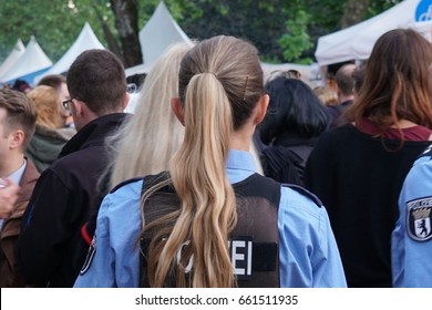 Berlin, Germany - June 4, 2017: Back Turned Female Police Officer At Work During A Street Parade. Law Enforcement In Germany Is Constitutionally Vested Solely With The States