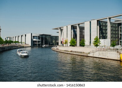 Berlin, Germany - June 4, 2019: Tourist Boat Doing Sightseeing Tour On River Spree At German Reichtag Building And Paul Löbe Haus In Berlin