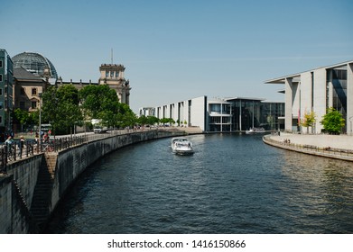 Berlin, Germany - June 4, 2019: Tourist Boat Doing Sightseeing Tour On River Spree At German Reichtag Building And Paul Löbe Haus In Berlin