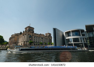 Berlin, Germany - June 4, 2019: Tourist Boat Doing Sightseeing Tour On River Spree At German Reichtag Building And Paul Löbe Haus In Berlin