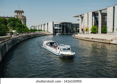 Berlin, Germany - June 4, 2019: Tourist Boat Doing Sightseeing Tour On River Spree At German Reichtag Building And Paul Löbe Haus In Berlin