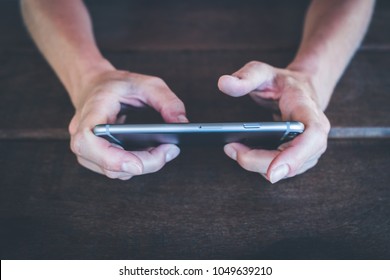 Berlin, Germany - March 2018: Closeup Of Woman Hand Holding IPhone 6 Silver. IPhone 6 Was Created And Developed By The Apple Inc